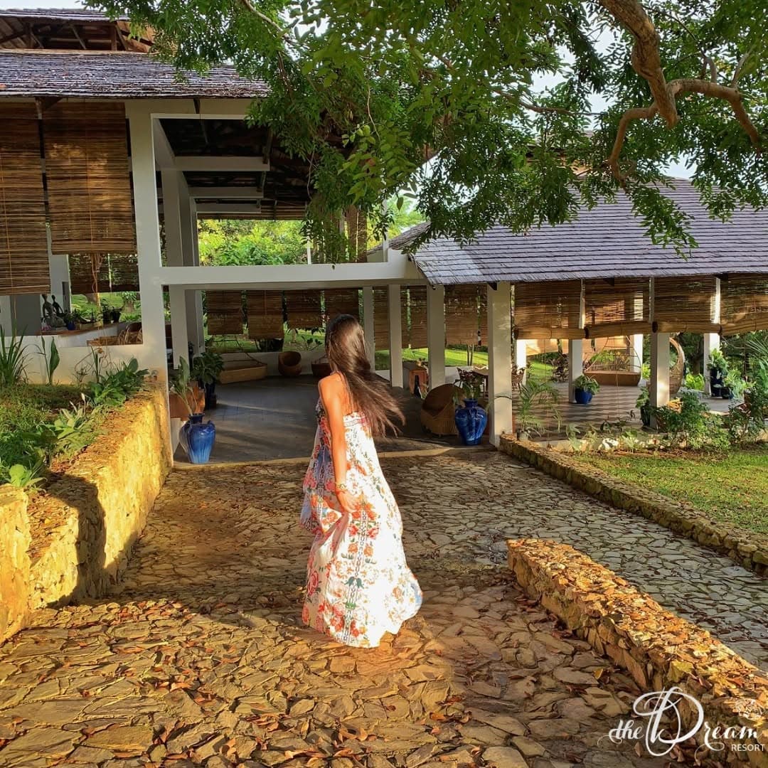 Golden-hour light on the stone path between the resort pavilions