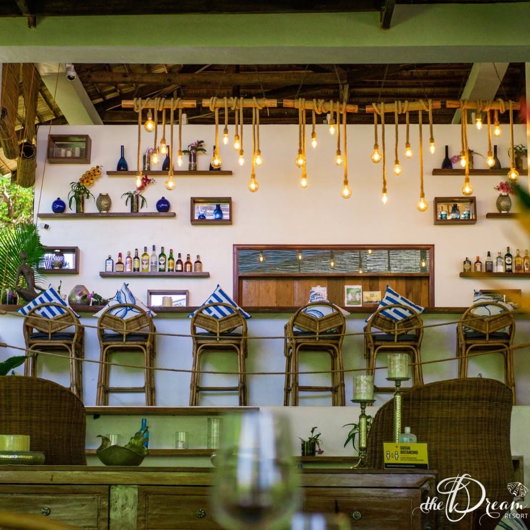 The bar with hanging filament bulbs and rattan stools