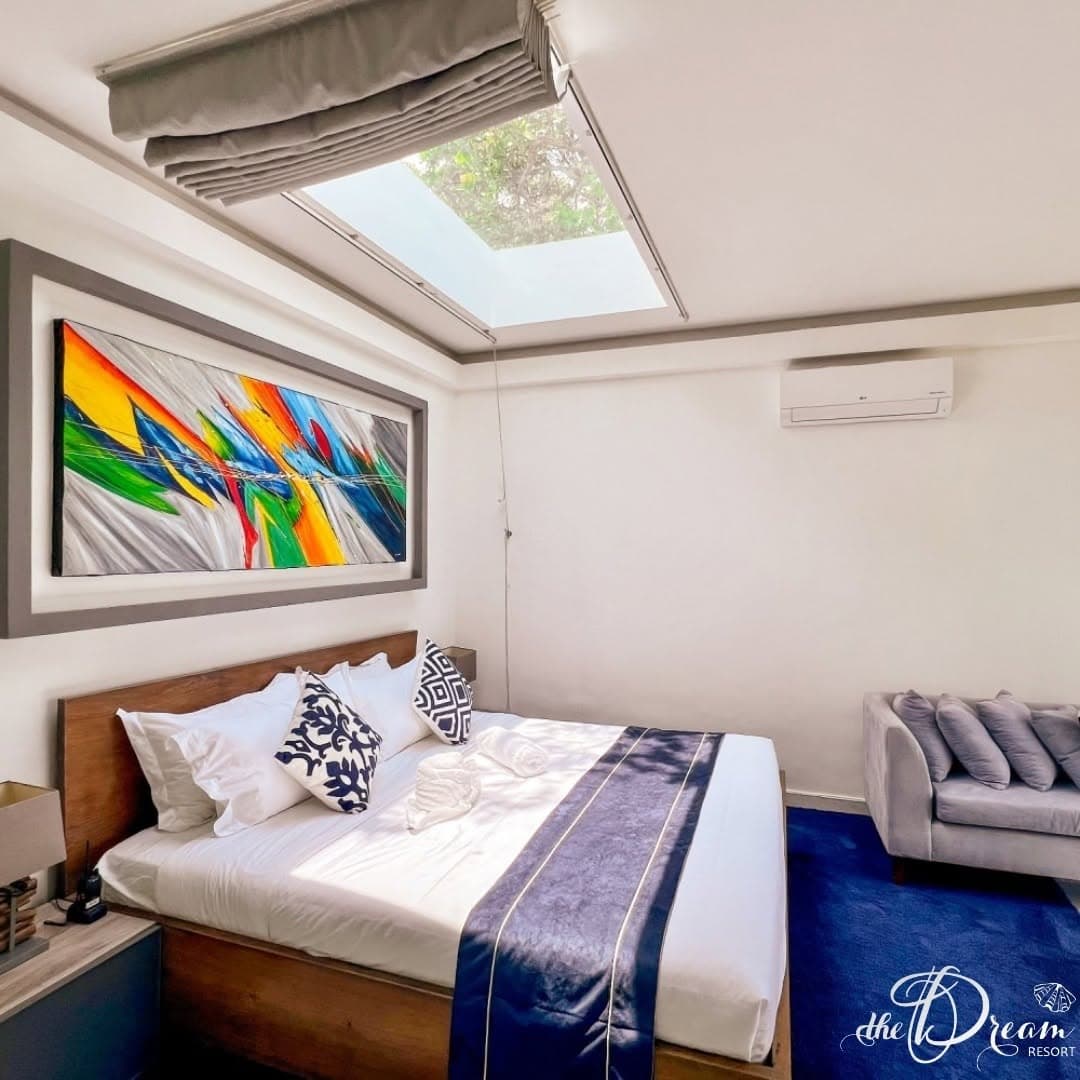 Sea View Garden Villa bedroom with stargazing skylight above the king bed